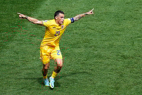 Nicolae Stanciu celebrates after scoring the opening goal